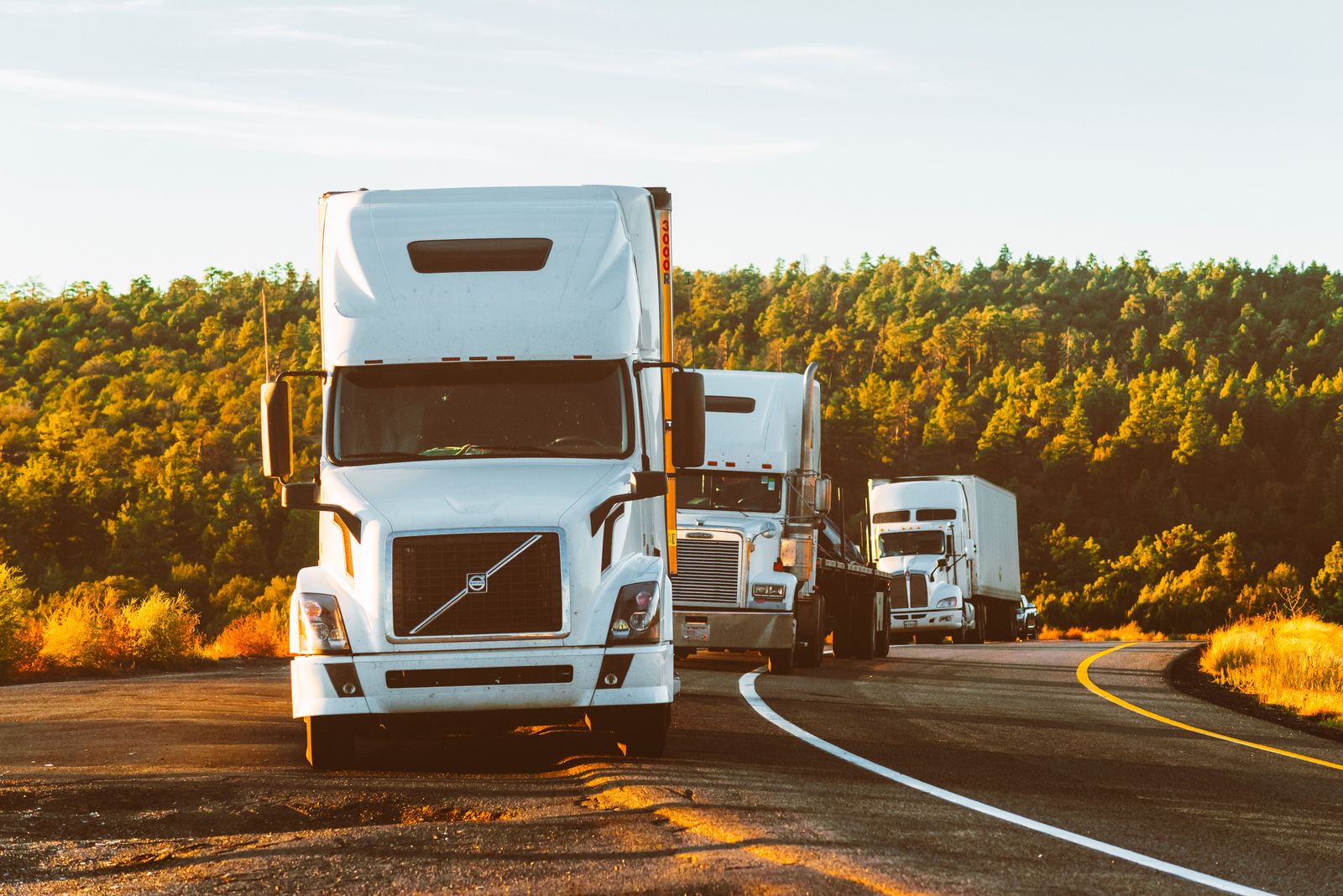 Freight trucks travelling together on a highway