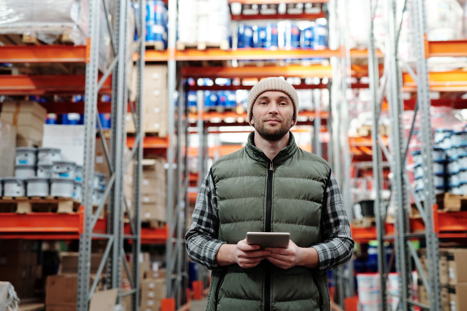 A warehouse manager checking freight details on a tablet